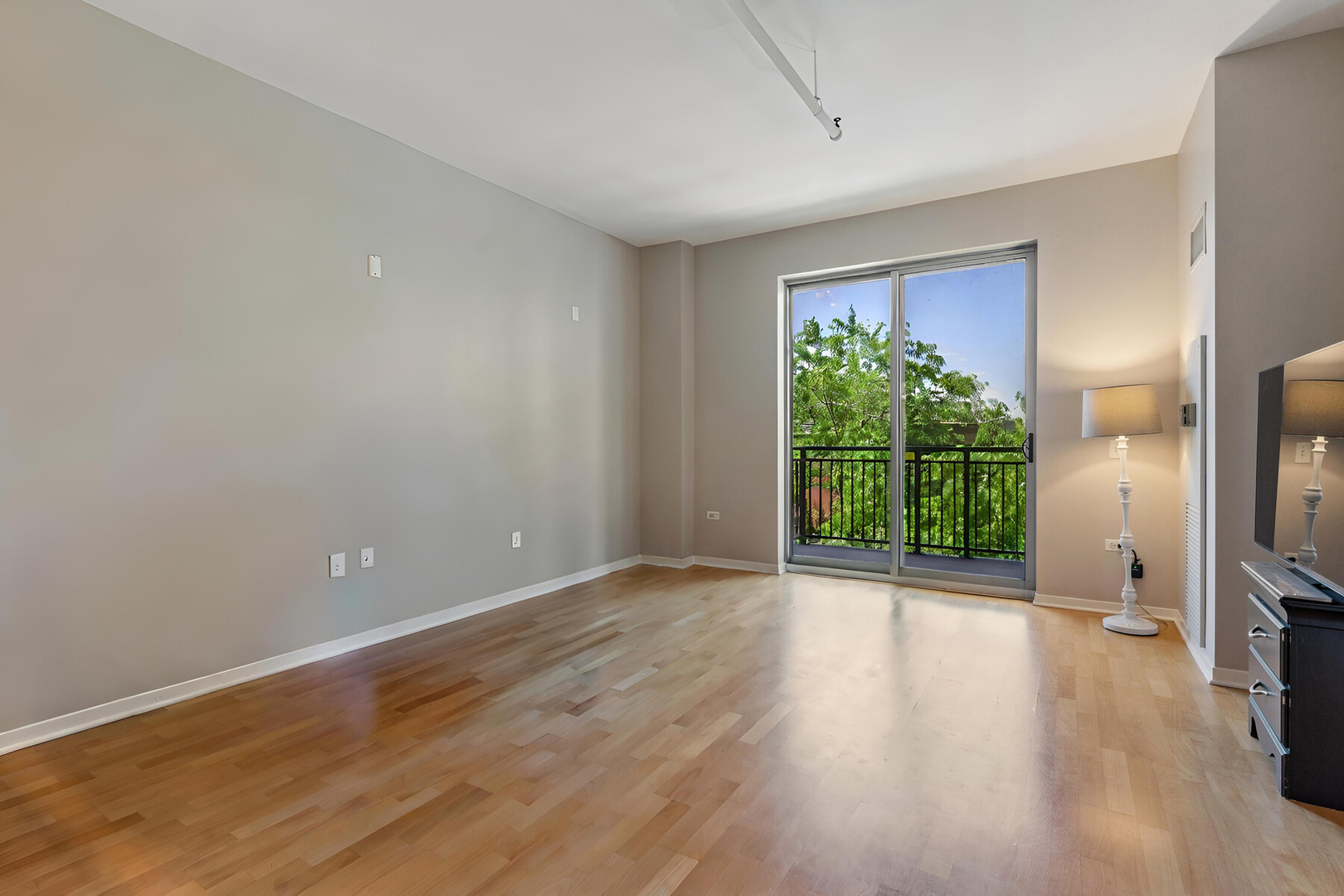 437 West Division Street, Unit 412 Chicago, IL 60610 - Photo 4 of 11 a view of a room with a flat screen tv and floor to ceiling window