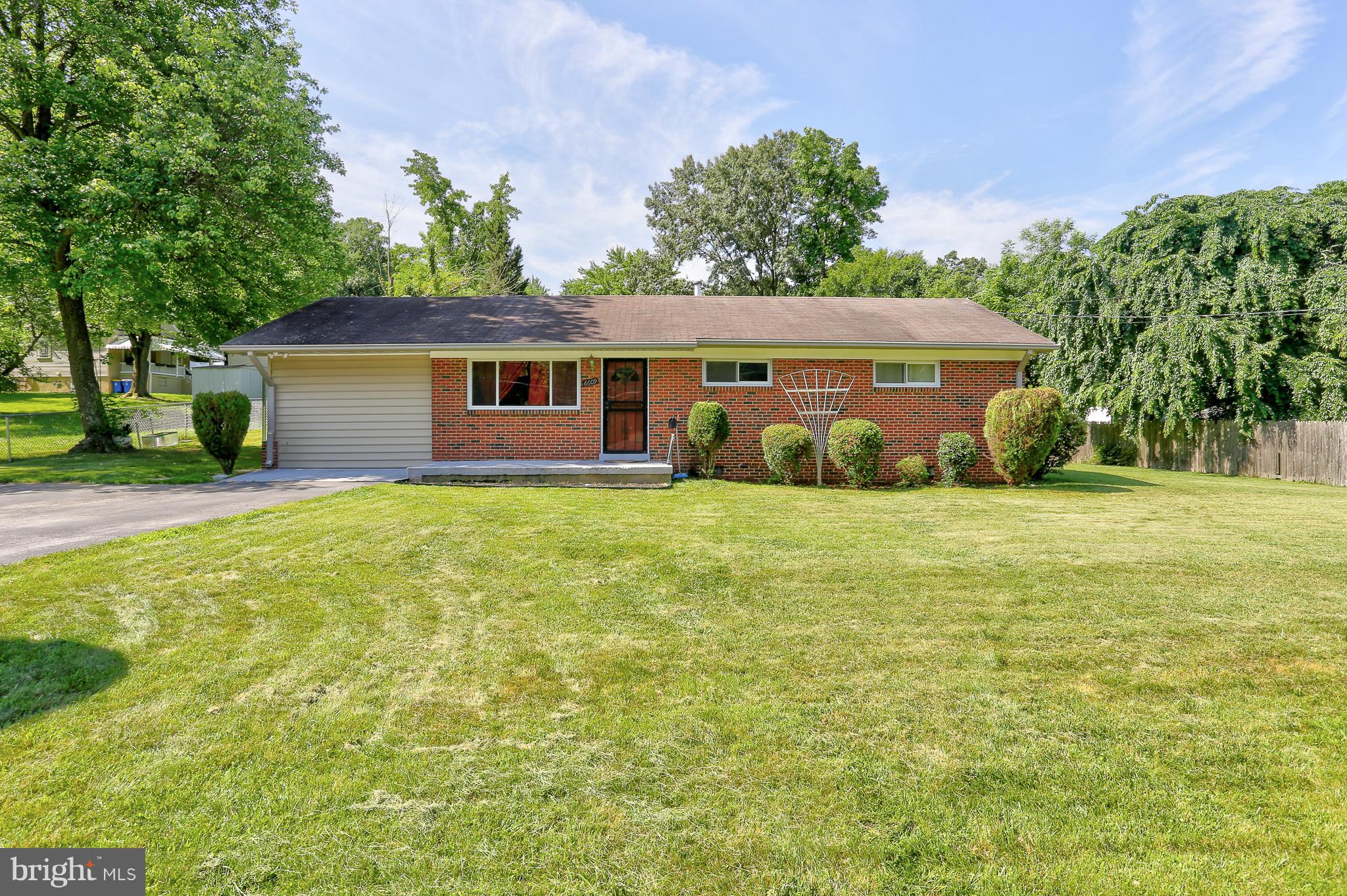 a view of a house with yard and tree s
