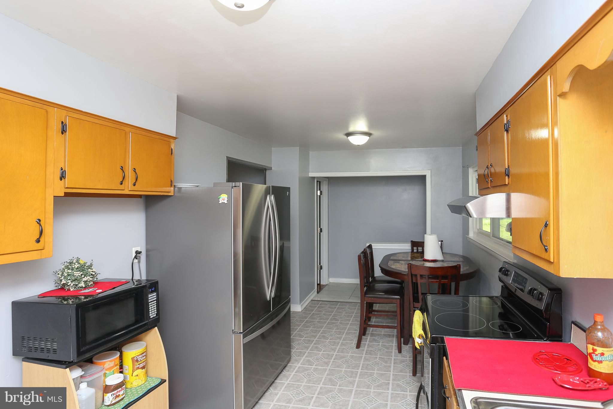 6609 Woodland Road Morningside, MD 20746 - Photo 12 of 30 a kitchen with stainless steel appliances granite countertop a refrigerator and a stove