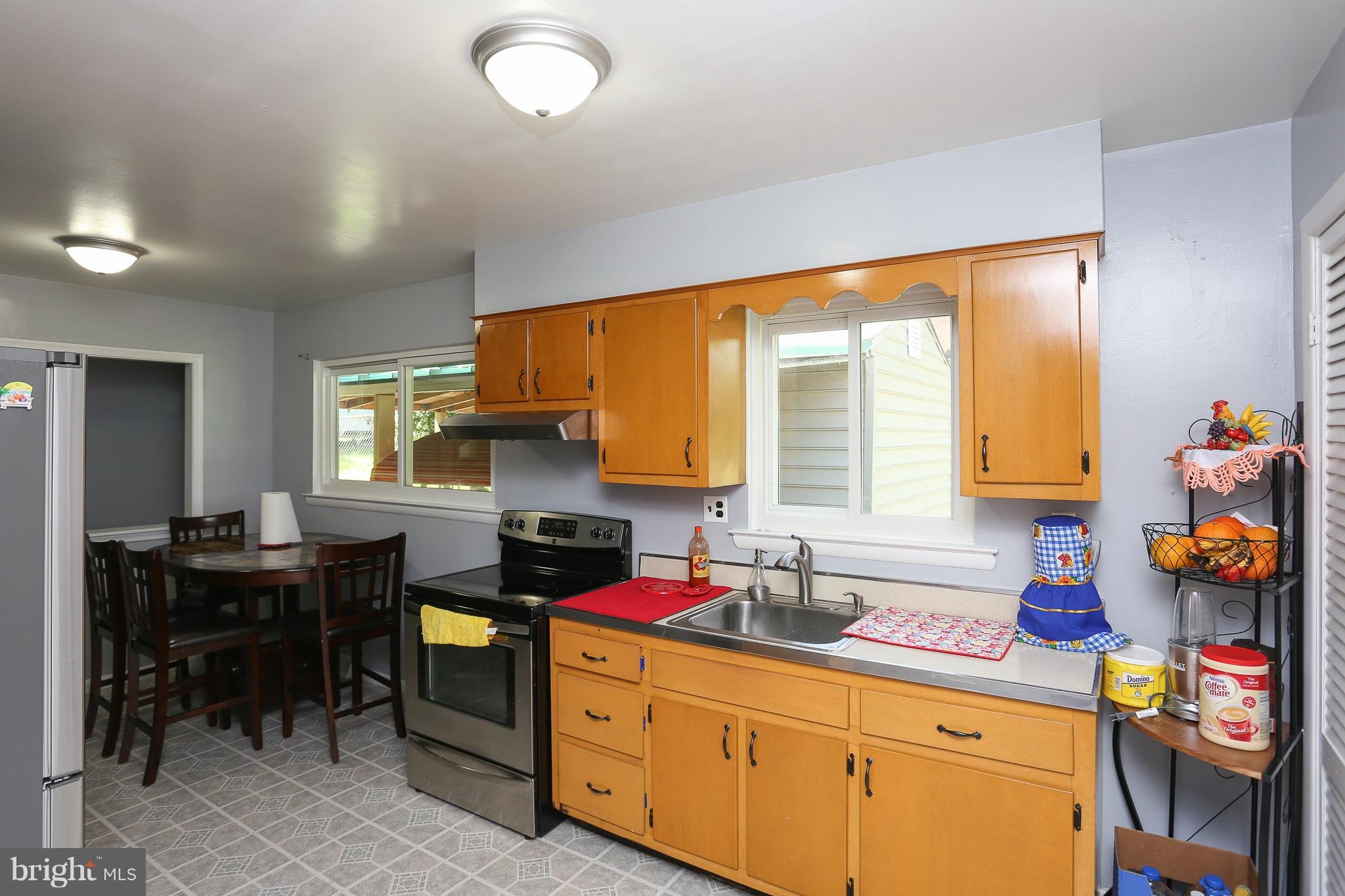 6609 Woodland Road Morningside, MD 20746 - Photo 13 of 30 a kitchen that has a sink and a chair in it