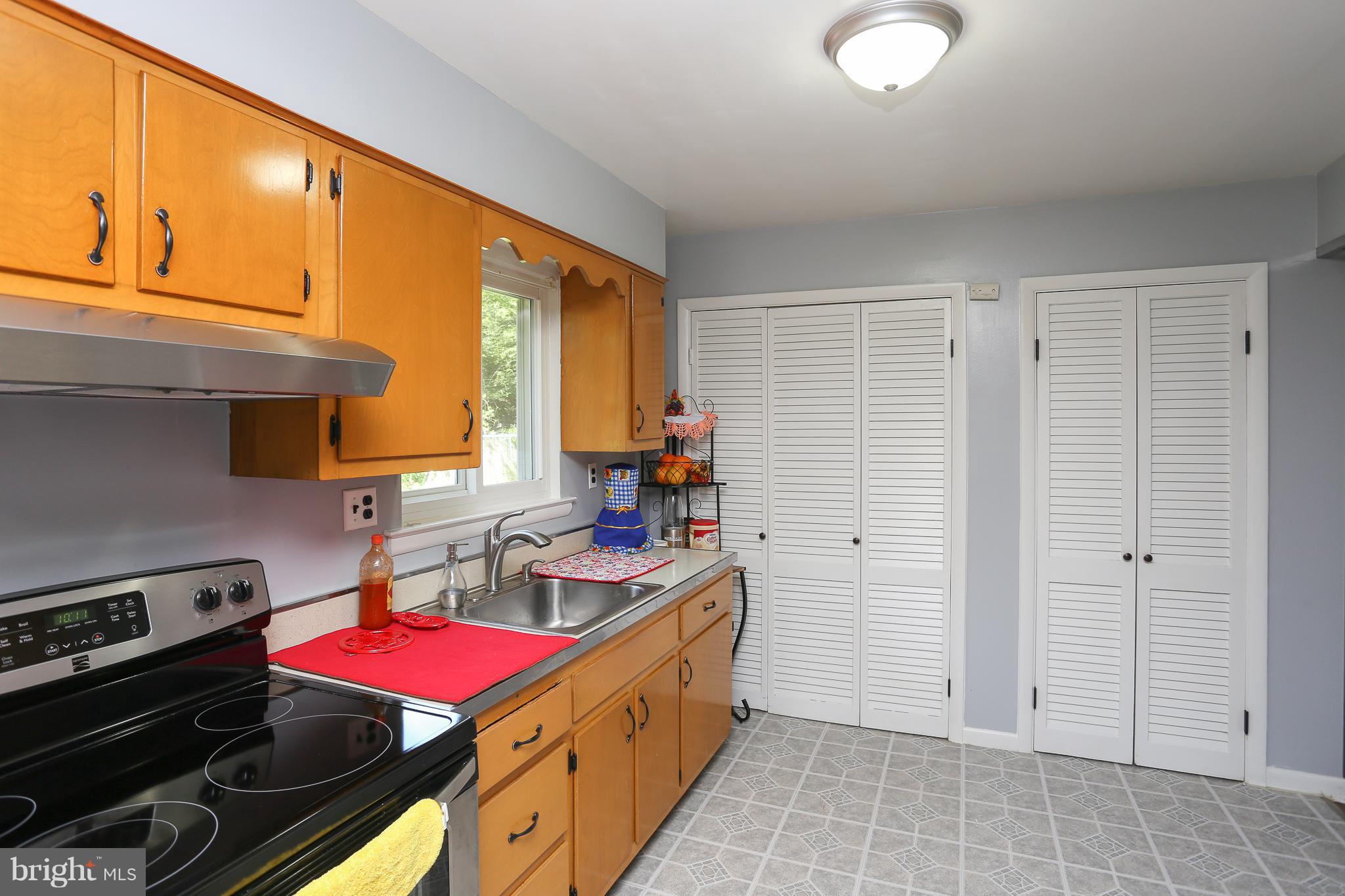 6609 Woodland Road Morningside, MD 20746 - Photo 14 of 30 a kitchen with a stove a sink and cabinets