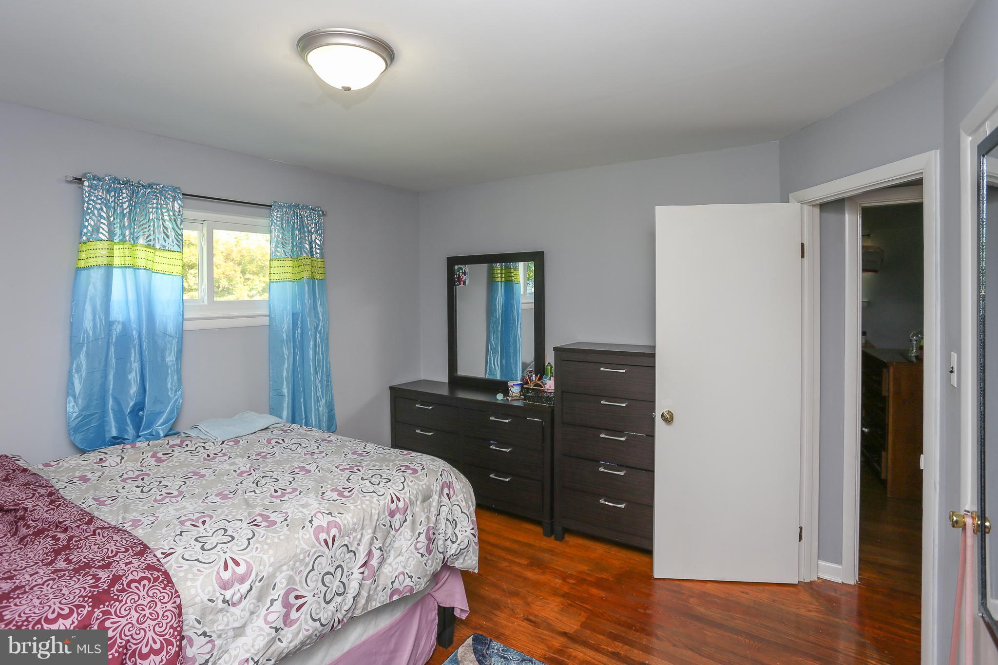 6609 Woodland Road Morningside, MD 20746 - Photo 18 of 30 a bedroom with a bed and a dresser