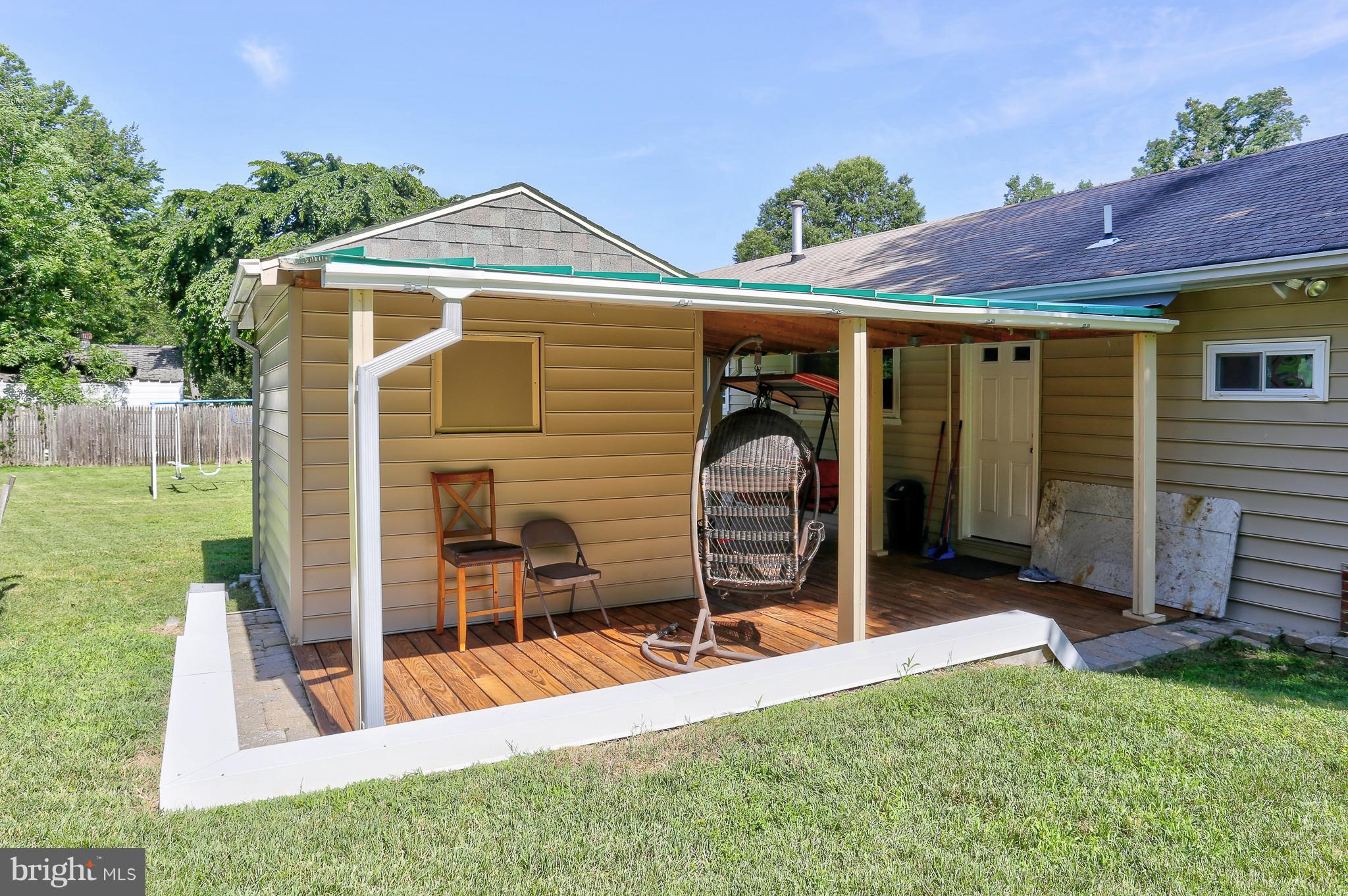 6609 Woodland Road Morningside, MD 20746 - Photo 25 of 30 a view of a house with backyard and porch