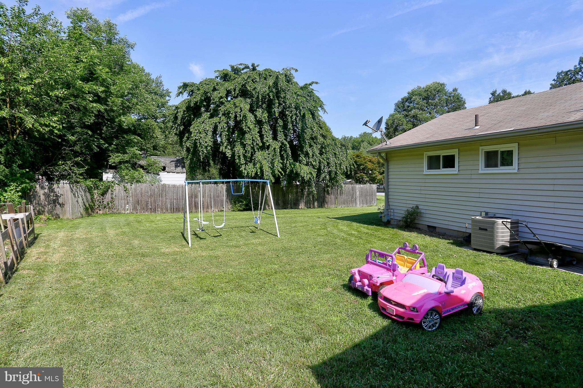 6609 Woodland Road Morningside, MD 20746 - Photo 29 of 30 a view of a backyard with a table and chair and potted plants