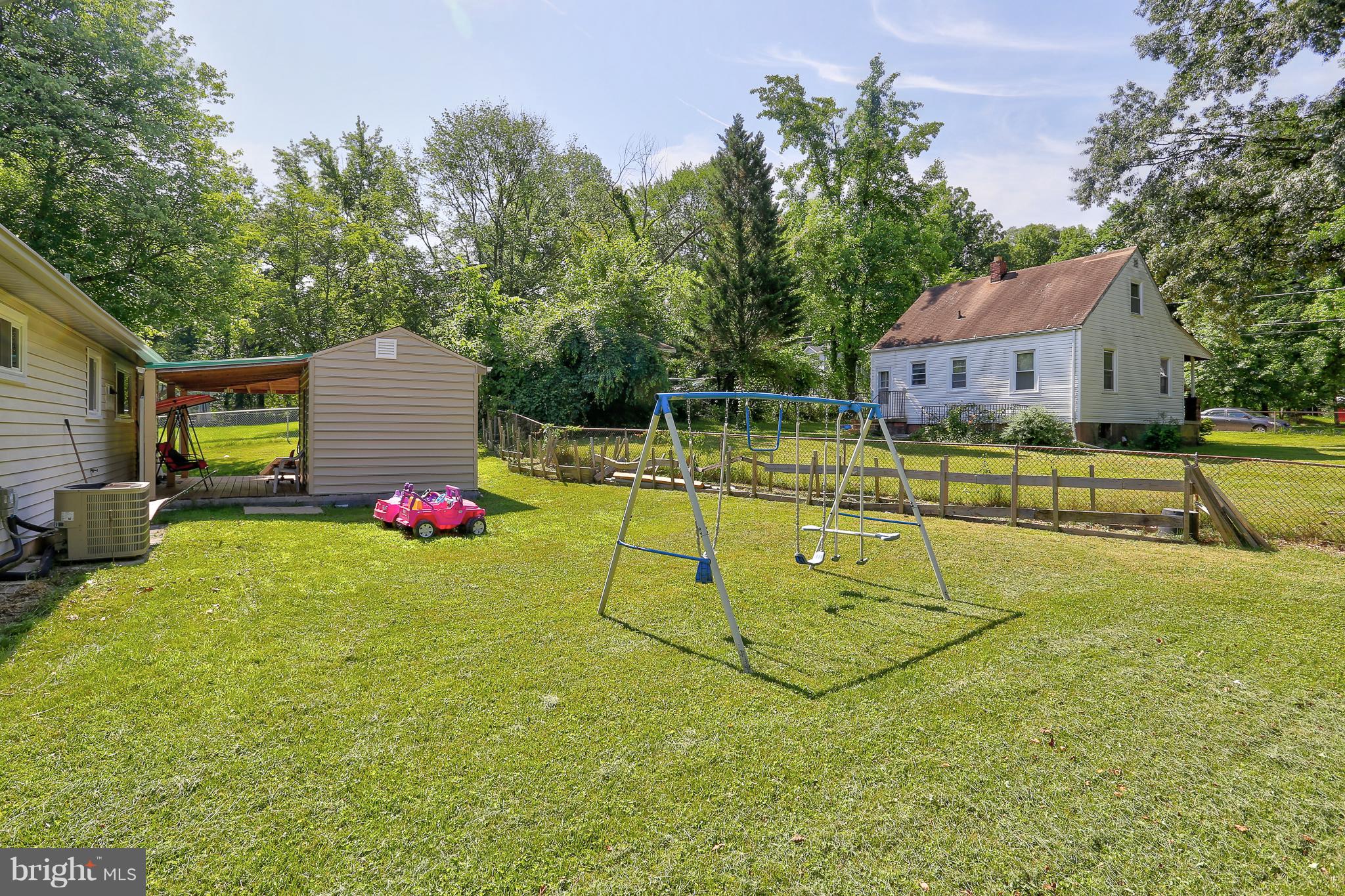 6609 Woodland Road Morningside, MD 20746 - Photo 30 of 30 a view of a house with swimming pool and a yard