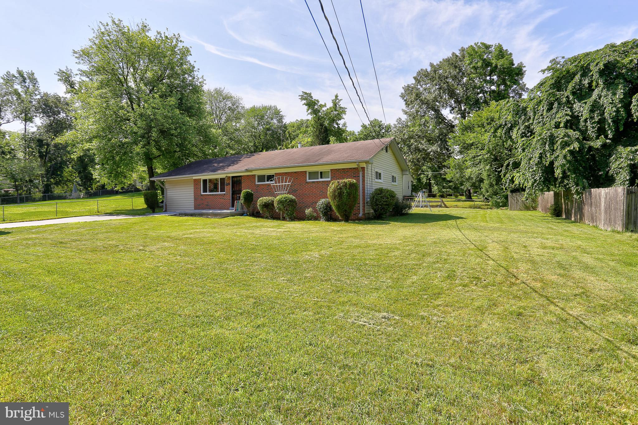 6609 Woodland Road Morningside, MD 20746 - Photo 4 of 30 a view of a house with a big yard