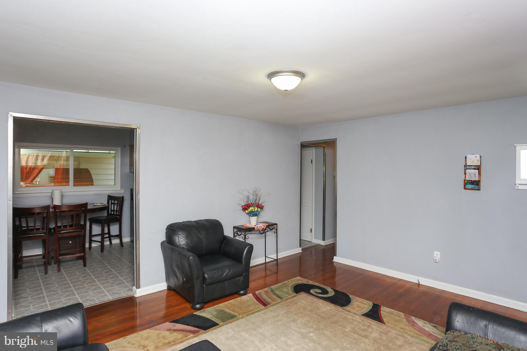 6609 Woodland Road Morningside, MD 20746 - Photo 6 of 30 a living room with furniture a piano and wooden floor