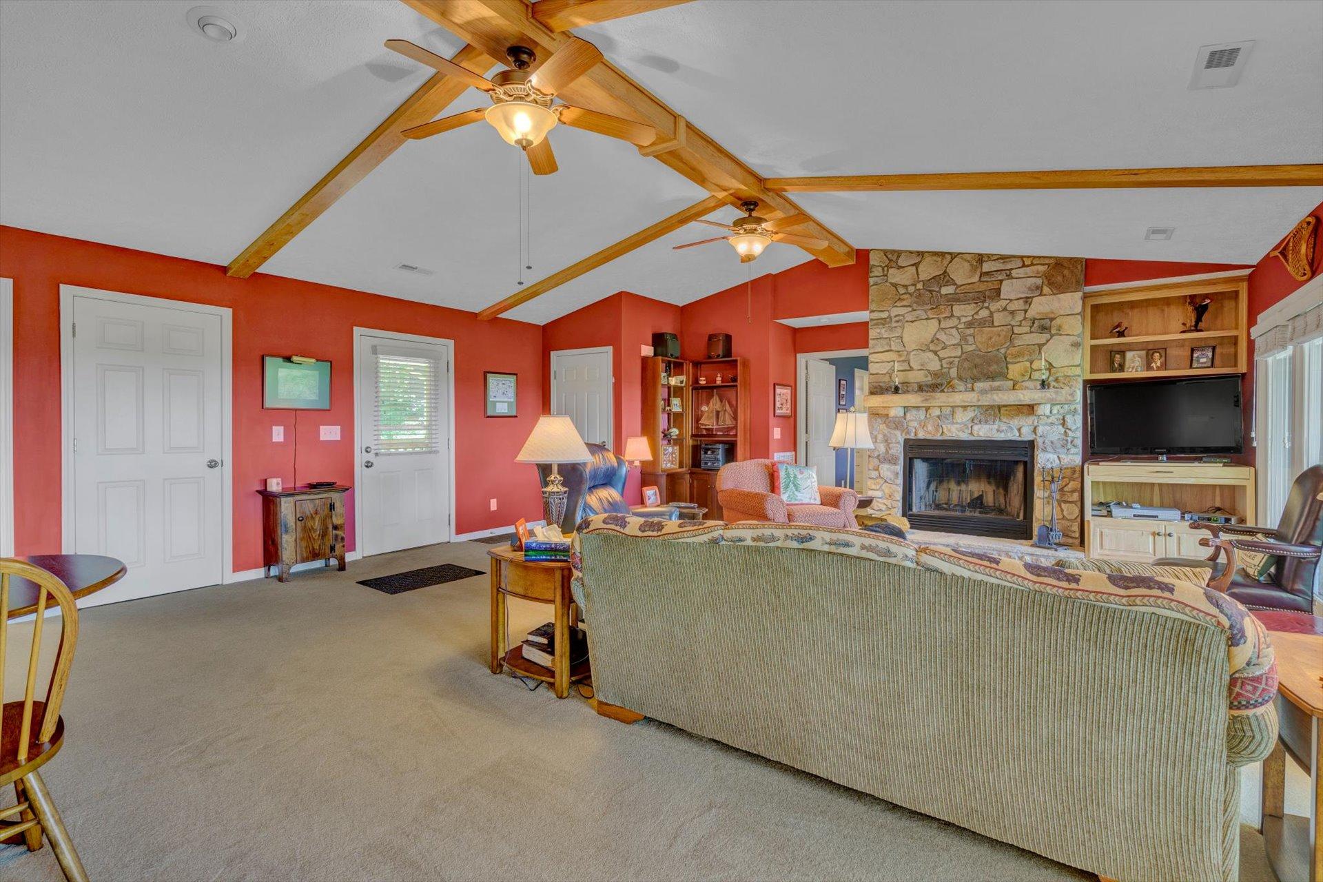 2005 Walnut Knob Road Southeast Floyd, VA 24091 - Photo 13 of 71 a living room with furniture a flat screen tv and a fireplace