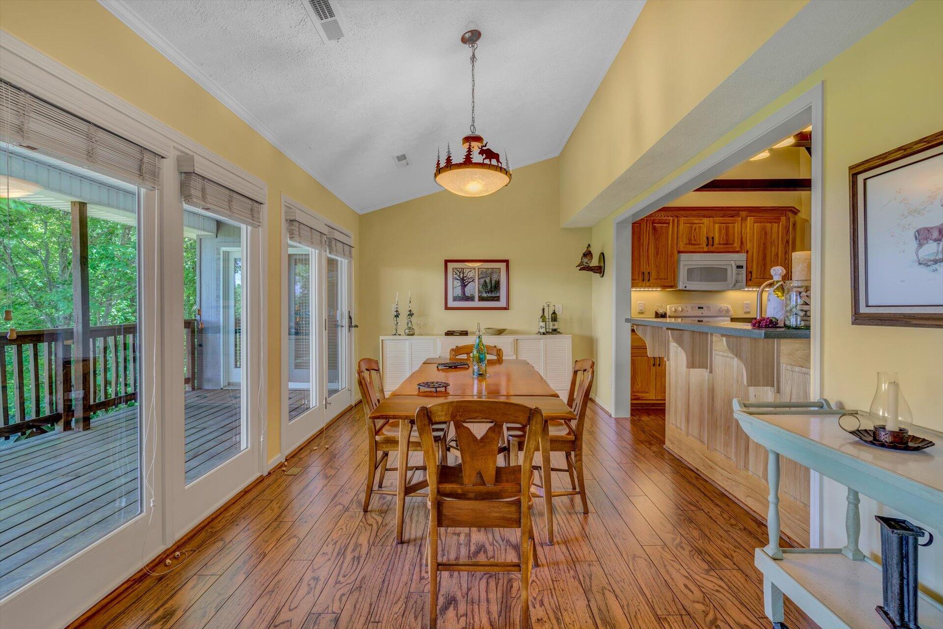 2005 Walnut Knob Road Southeast Floyd, VA 24091 - Photo 19 of 71 a dining room with wooden floor a chandelier a wooden table and chairs