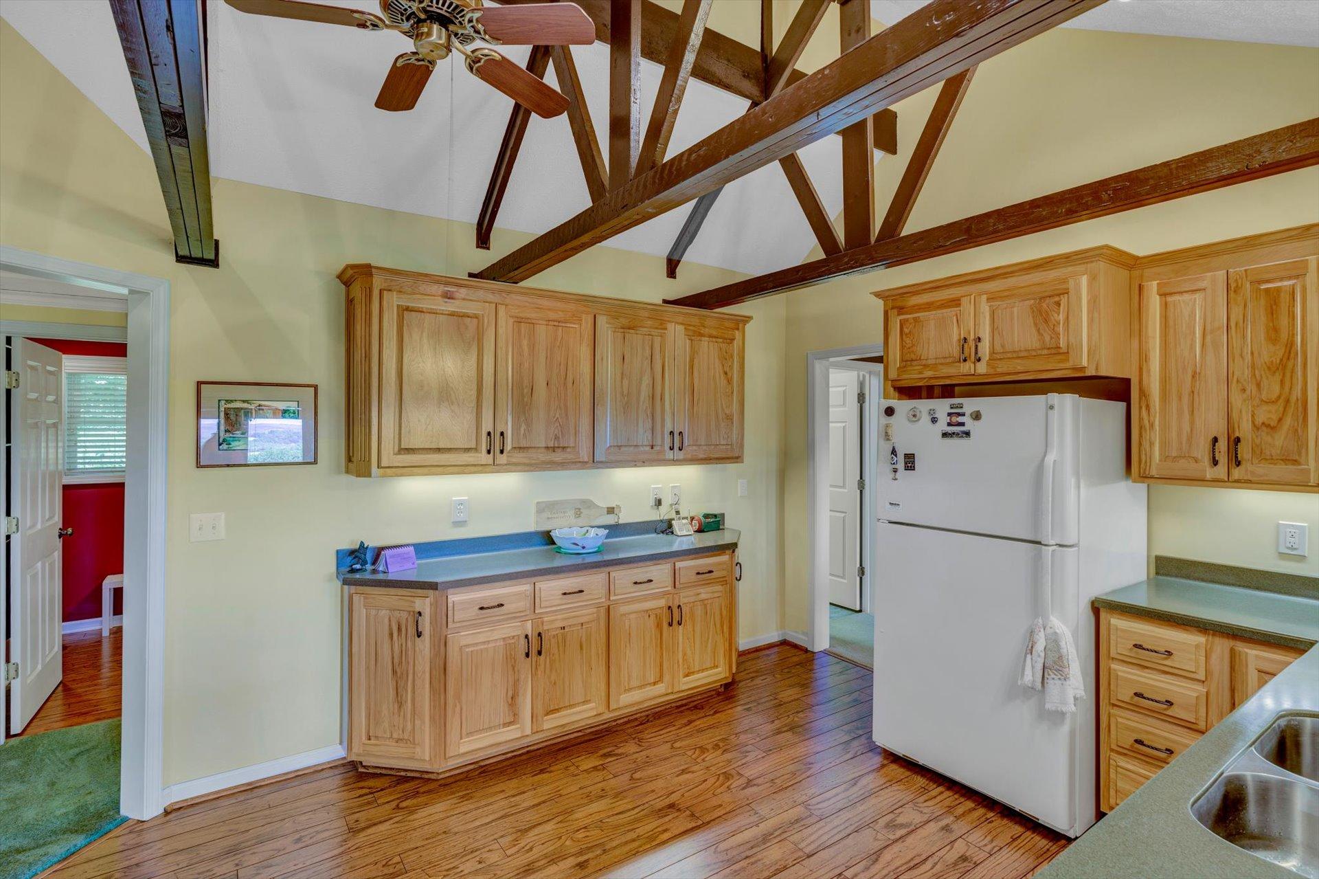2005 Walnut Knob Road Southeast Floyd, VA 24091 - Photo 23 of 71 a kitchen with stainless steel appliances granite countertop a refrigerator a stove and a wooden floors