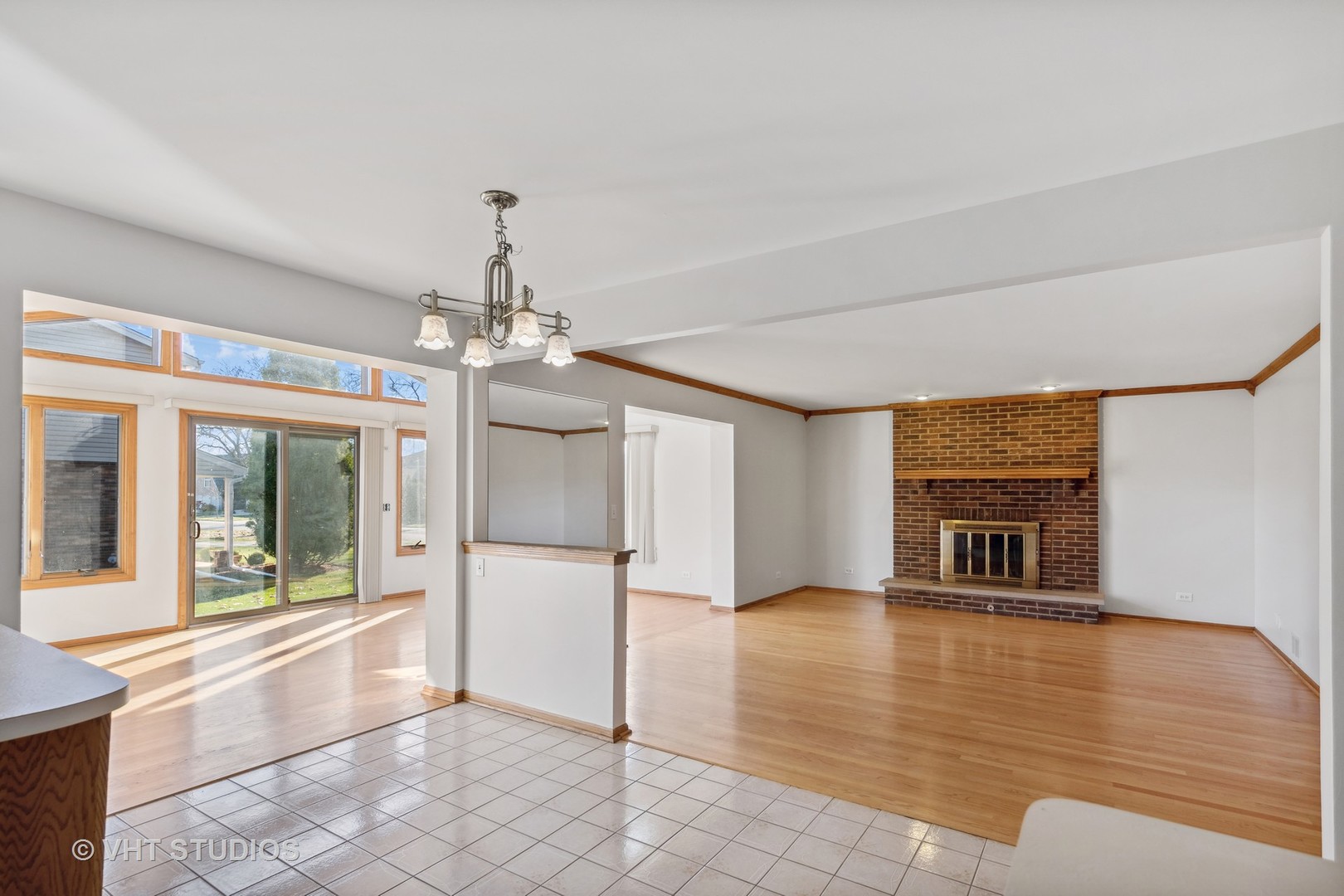 1101 Itasca Road Addison, IL 60101 - Photo 8 of 19 a view of a livingroom with a chandelier fireplace and windows