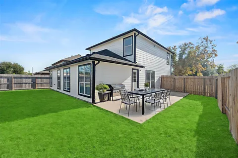 a view of a house with a yard and sitting area
