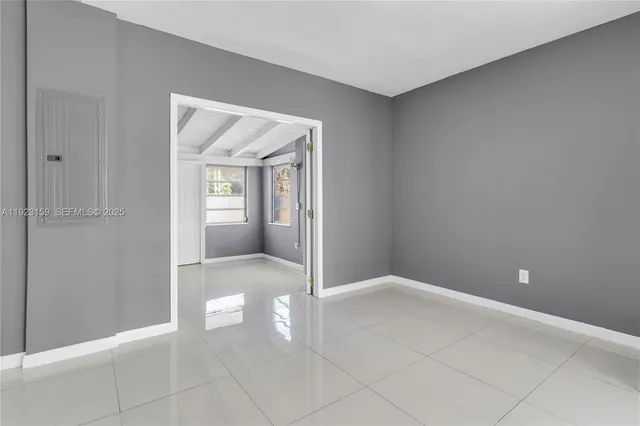 a kitchen with a refrigerator sink and white cabinets