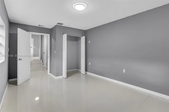 a white toilet sitting next to a shower