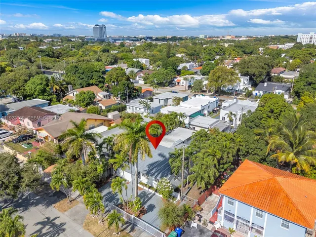an aerial view of a house with a yard