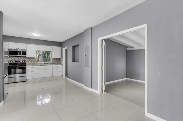 a view of a kitchen with microwave and cabinets