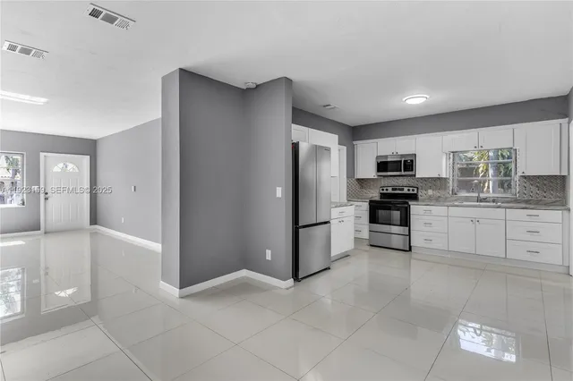 a kitchen with granite countertop cabinets and stainless steel appliances