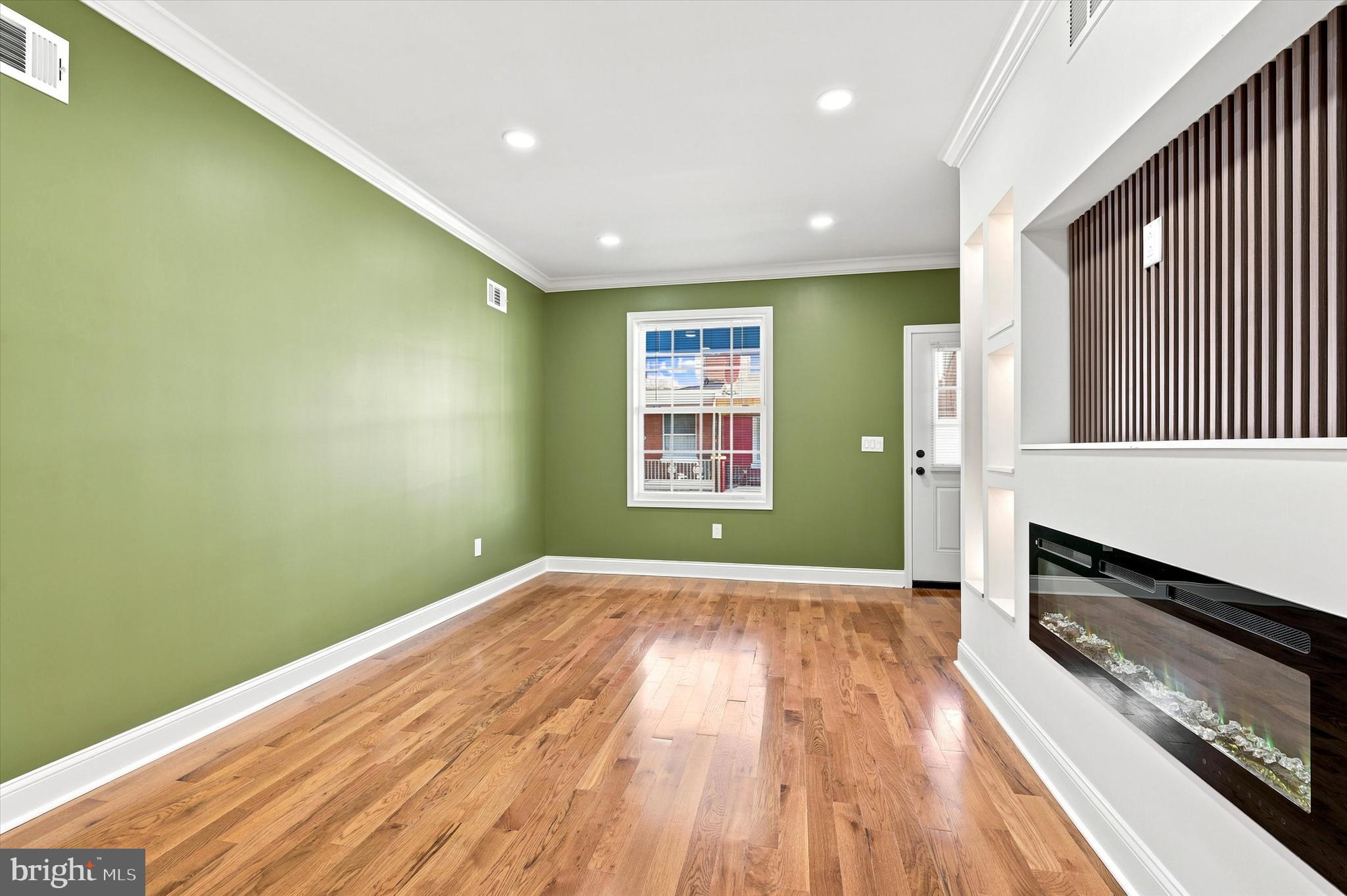 1620 South Yewdall Street Philadelphia, PA 19143 - Photo 7 of 38 a view of a room with wooden floor a ceiling fan and windows