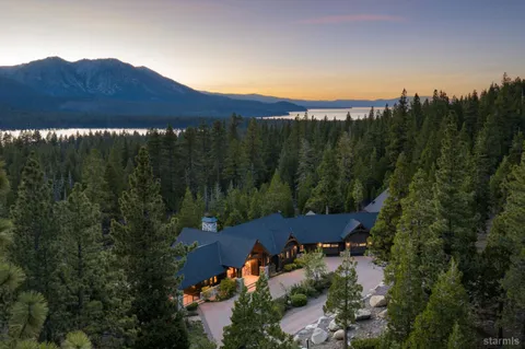 an aerial view of a house and mountain view