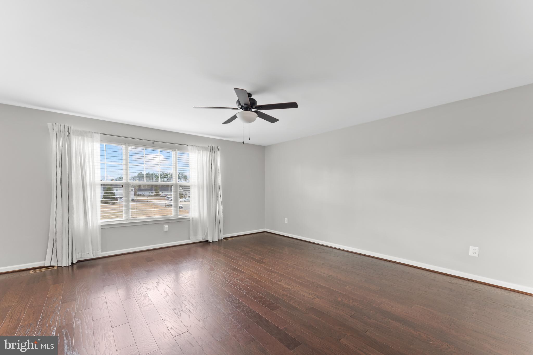 18315 Congressional Circle Ruther Glen, VA 22546 - Photo 11 of 37 an empty room with wooden floor fan and windows