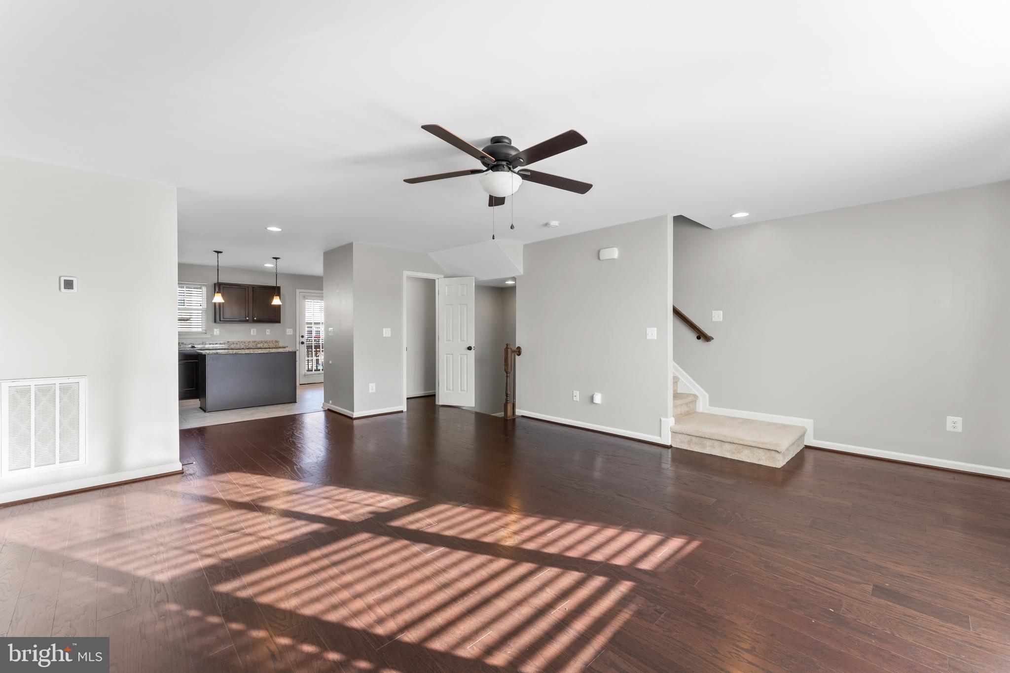 18315 Congressional Circle Ruther Glen, VA 22546 - Photo 13 of 37 a view of kitchen and empty room with wooden floor