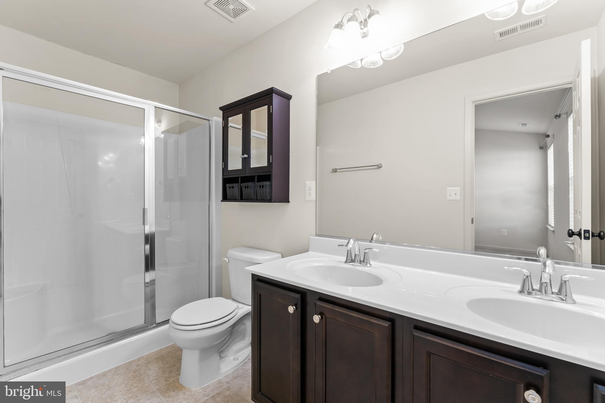 18315 Congressional Circle Ruther Glen, VA 22546 - Photo 23 of 37 a bathroom with a sink a toilet and shower