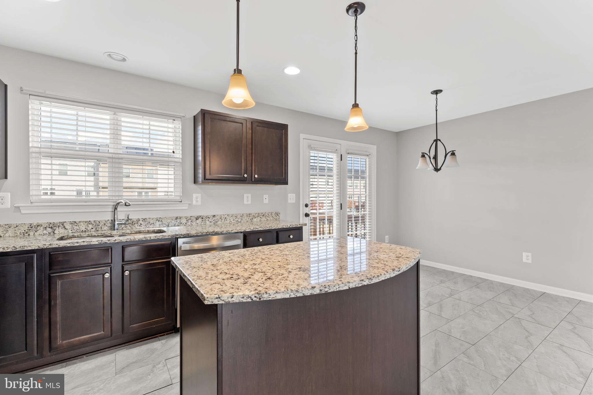 18315 Congressional Circle Ruther Glen, VA 22546 - Photo 32 of 37 a kitchen with a sink a center island and cabinets