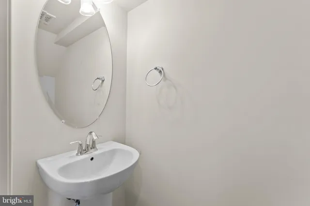 a bathroom with a sink and mirror