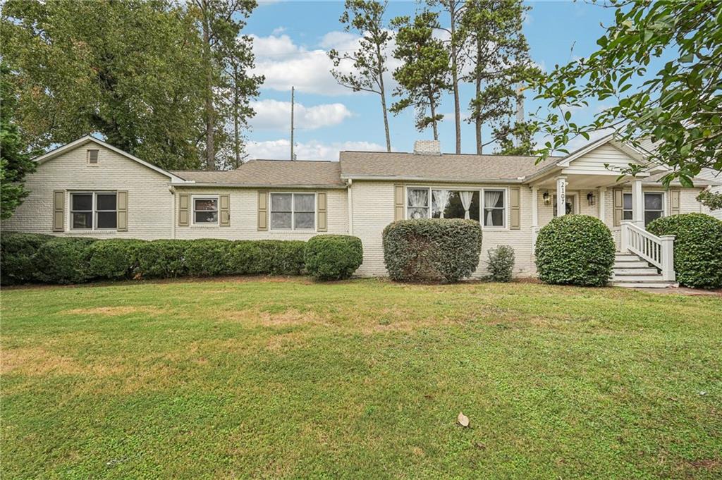 a front view of a house with a garden