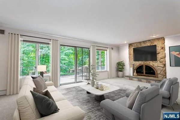 a living room with furniture a large window and a flat screen tv
