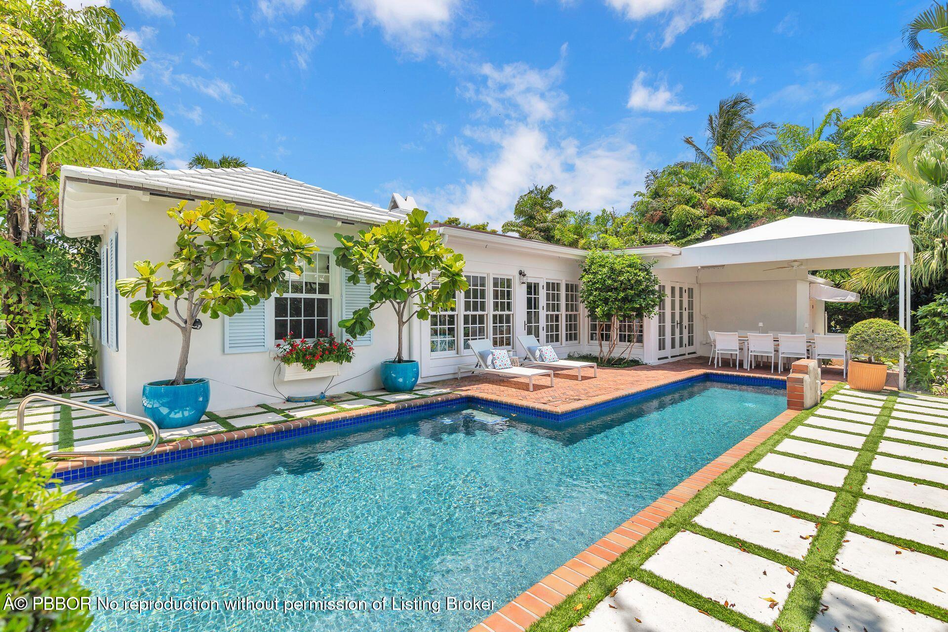 255 Colonial Lane Palm Beach, FL 33480 - Photo 25 of 32 a view of a house with swimming pool and porch with furniture