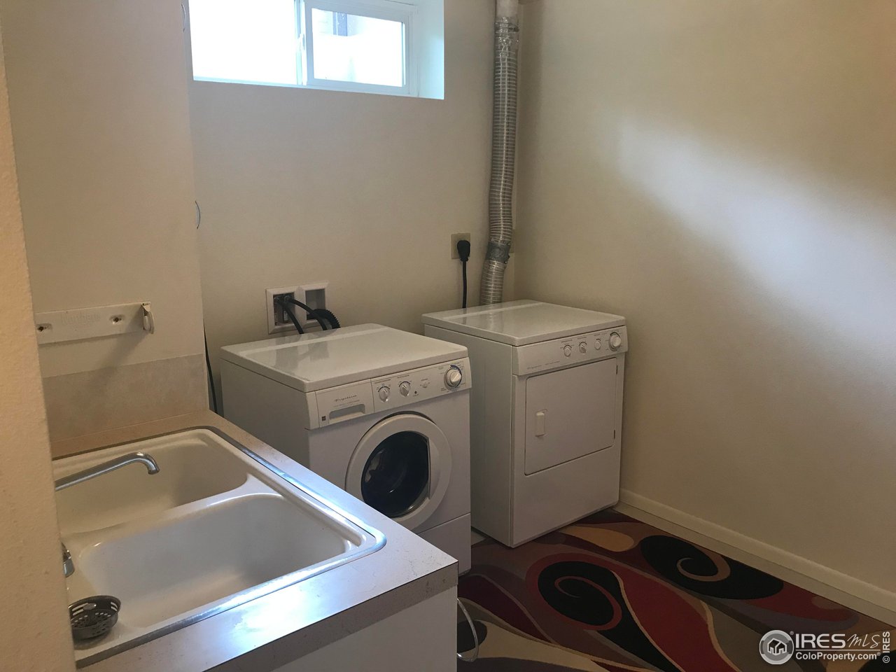 2127 14th Street Road Greeley, CO 80631 - Photo 32 of 36 Laundry with sink area in bsmt. Washer/dryer included