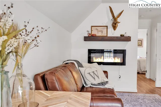 a bedroom with bed and wooden floor