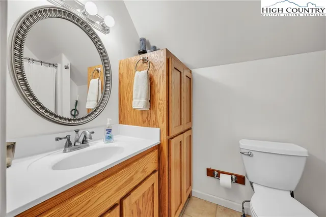 a bathroom with a sink vanity granite tub and a mirror