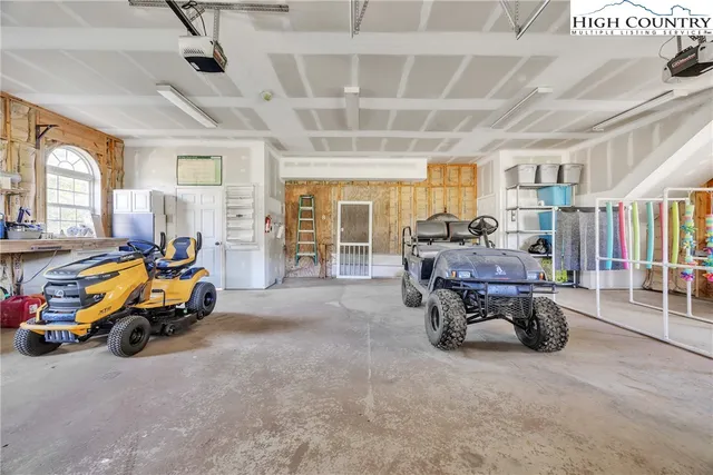 a living room with lots of furniture and a large window