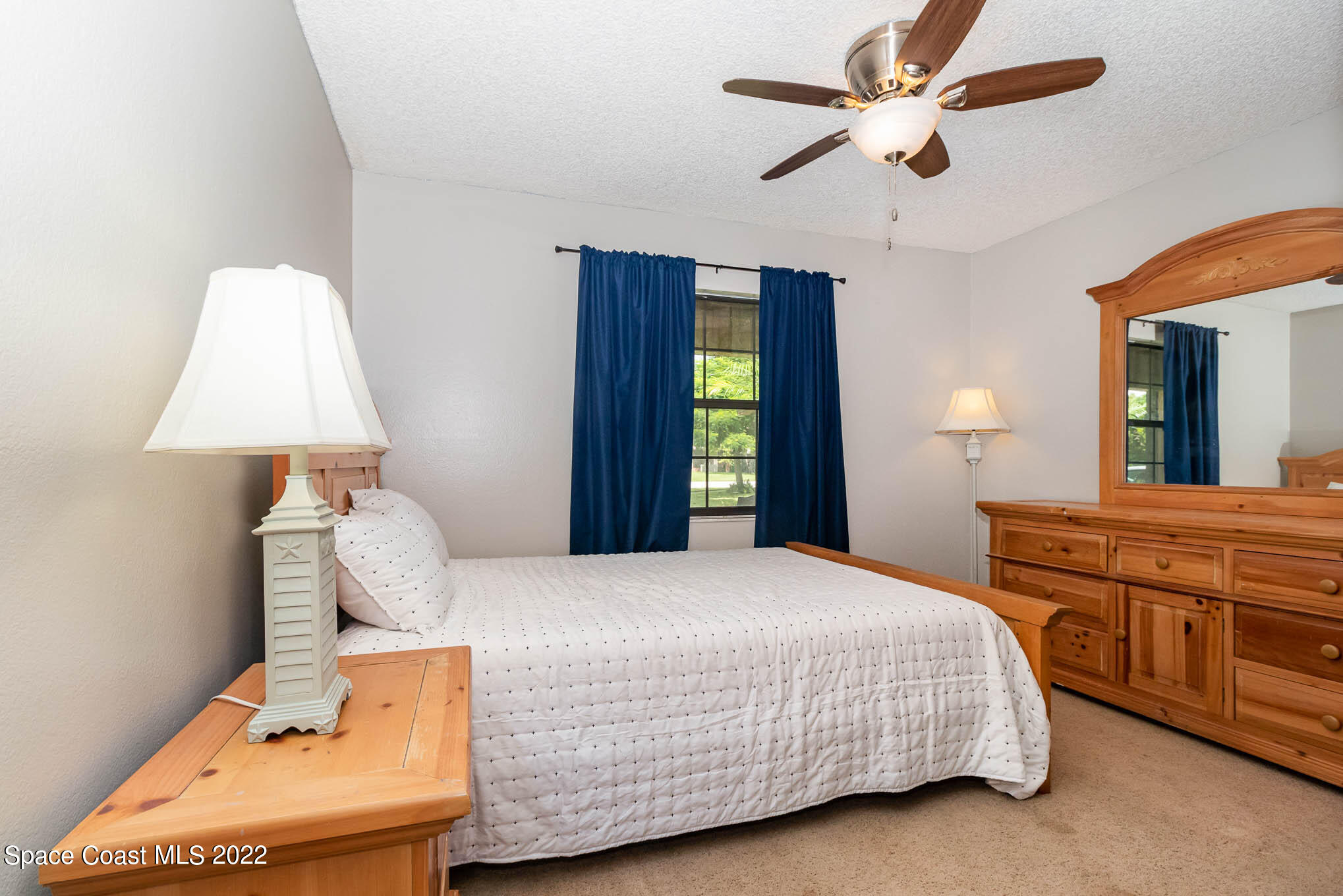 2539 Fulton Court Melbourne, FL 32935 - Photo 13 of 19 a bedroom with a bed and a chandelier