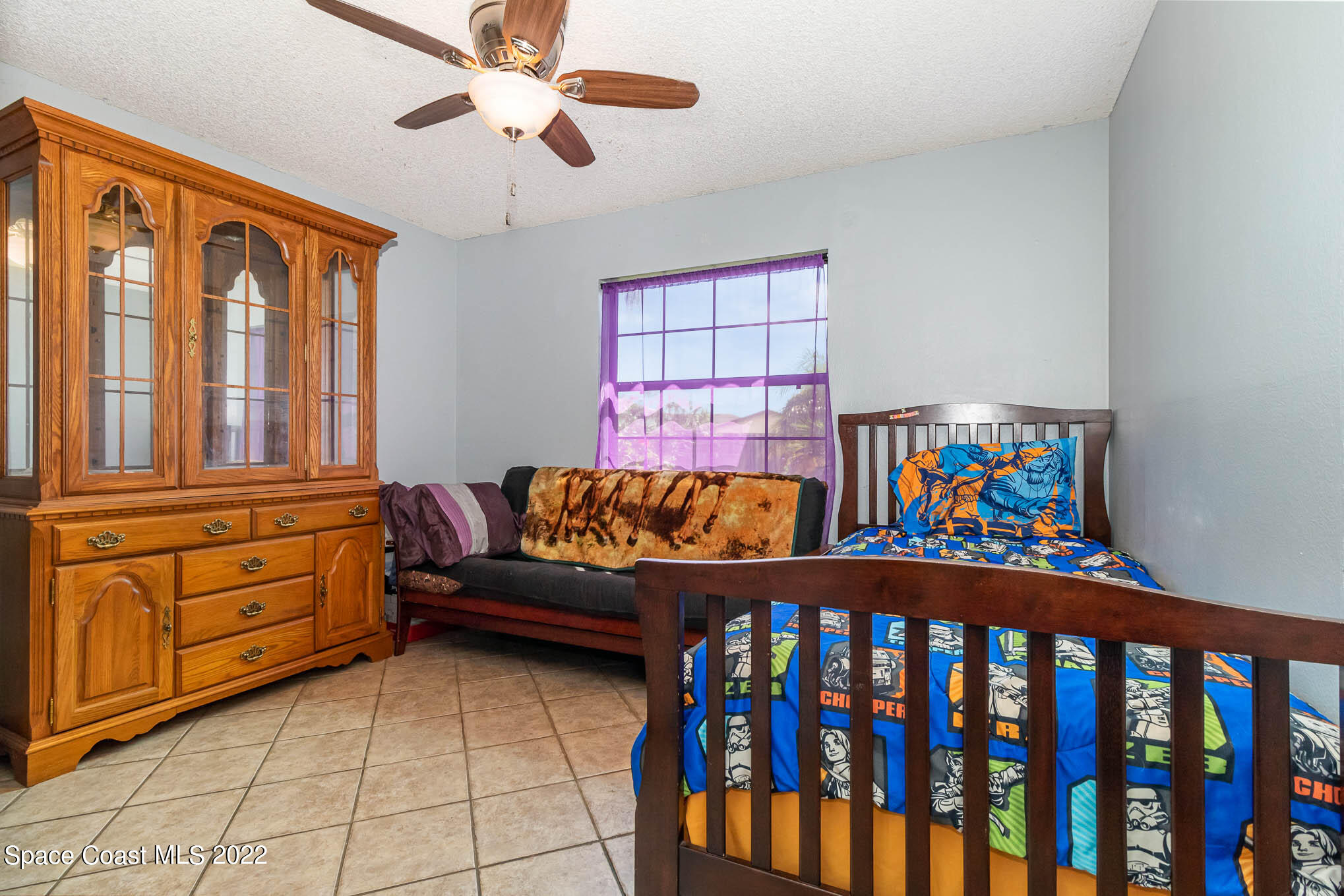 2539 Fulton Court Melbourne, FL 32935 - Photo 16 of 19 a bedroom with furniture and a baby crib
