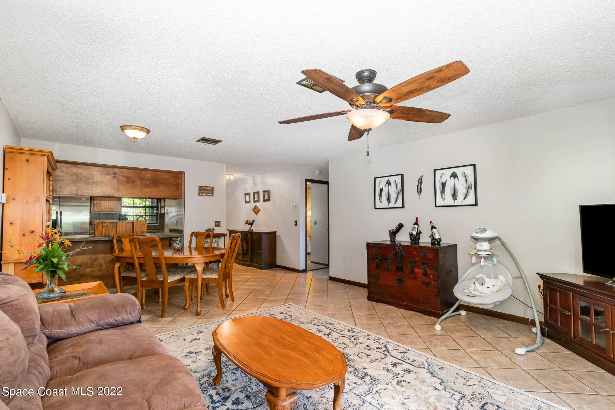 2539 Fulton Court Melbourne, FL 32935 - Photo 4 of 19 a living room with furniture kitchen view and a window