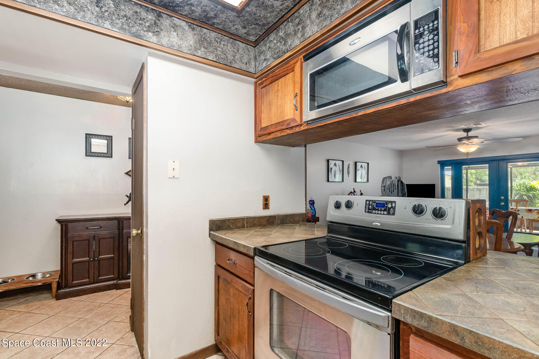 2539 Fulton Court Melbourne, FL 32935 - Photo 6 of 19 a kitchen with stainless steel appliances granite countertop a stove and a microwave
