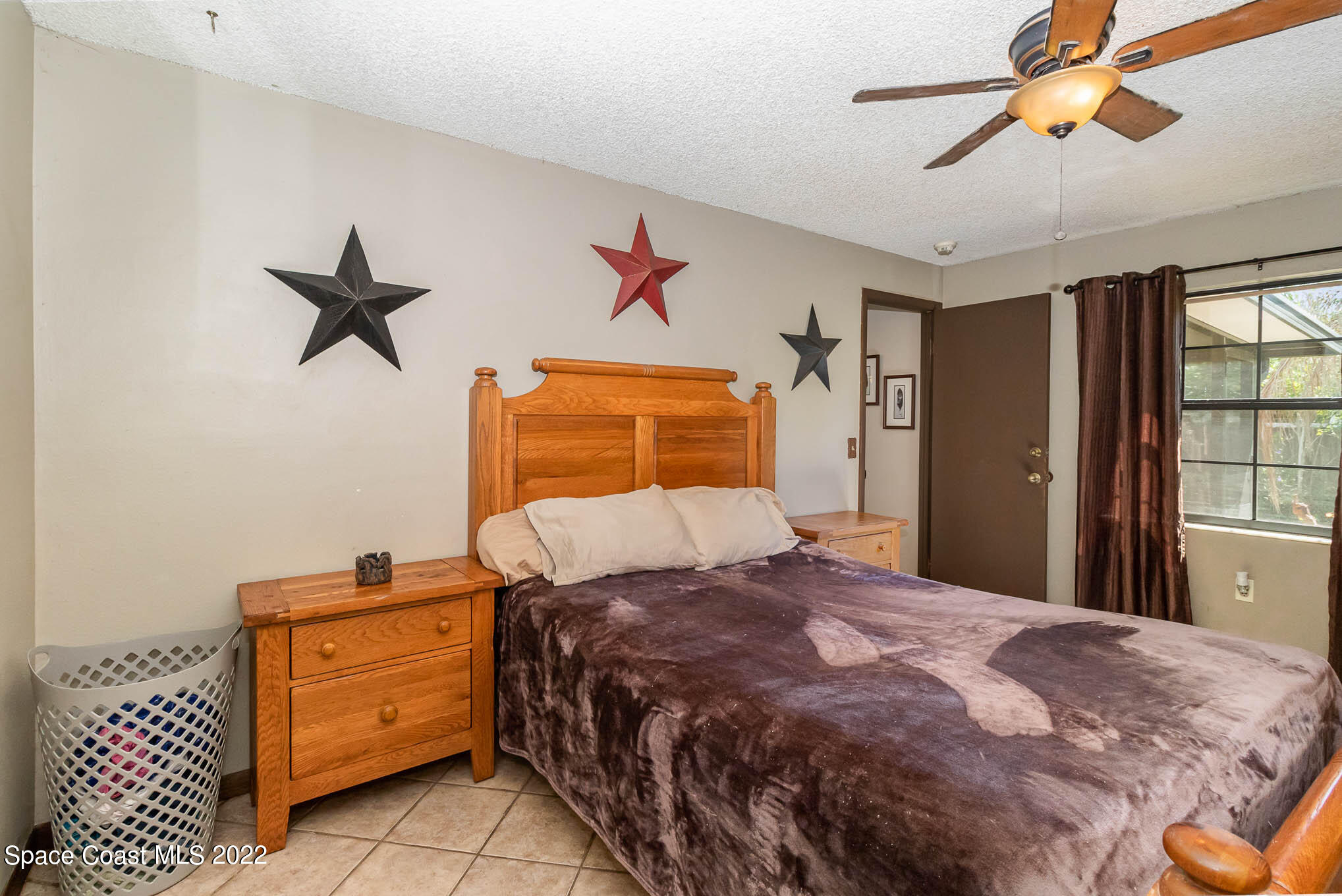 2539 Fulton Court Melbourne, FL 32935 - Photo 8 of 19 a bedroom with a bed and a window