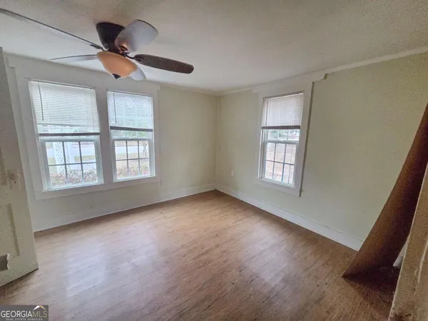 a view of hallway with wooden floor