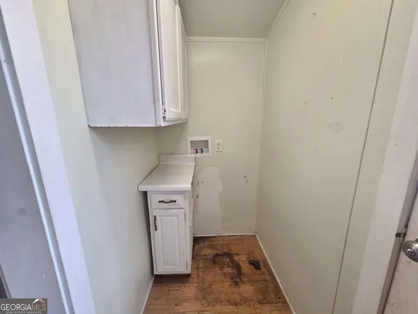 a utility room with a sink a refrigerator and washer