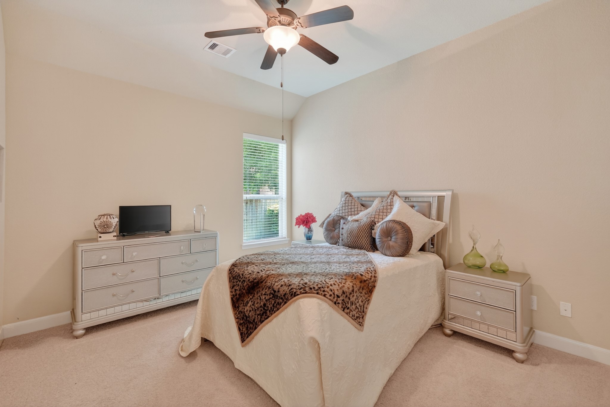 55 South Victoriana Circle Spring, TX 77389 - Photo 29 of 40 a bedroom with a bed and a chandelier