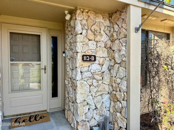 a view of bathroom with a shower and a window