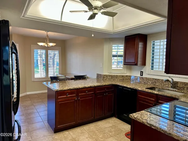 a kitchen with a sink a counter space and a window