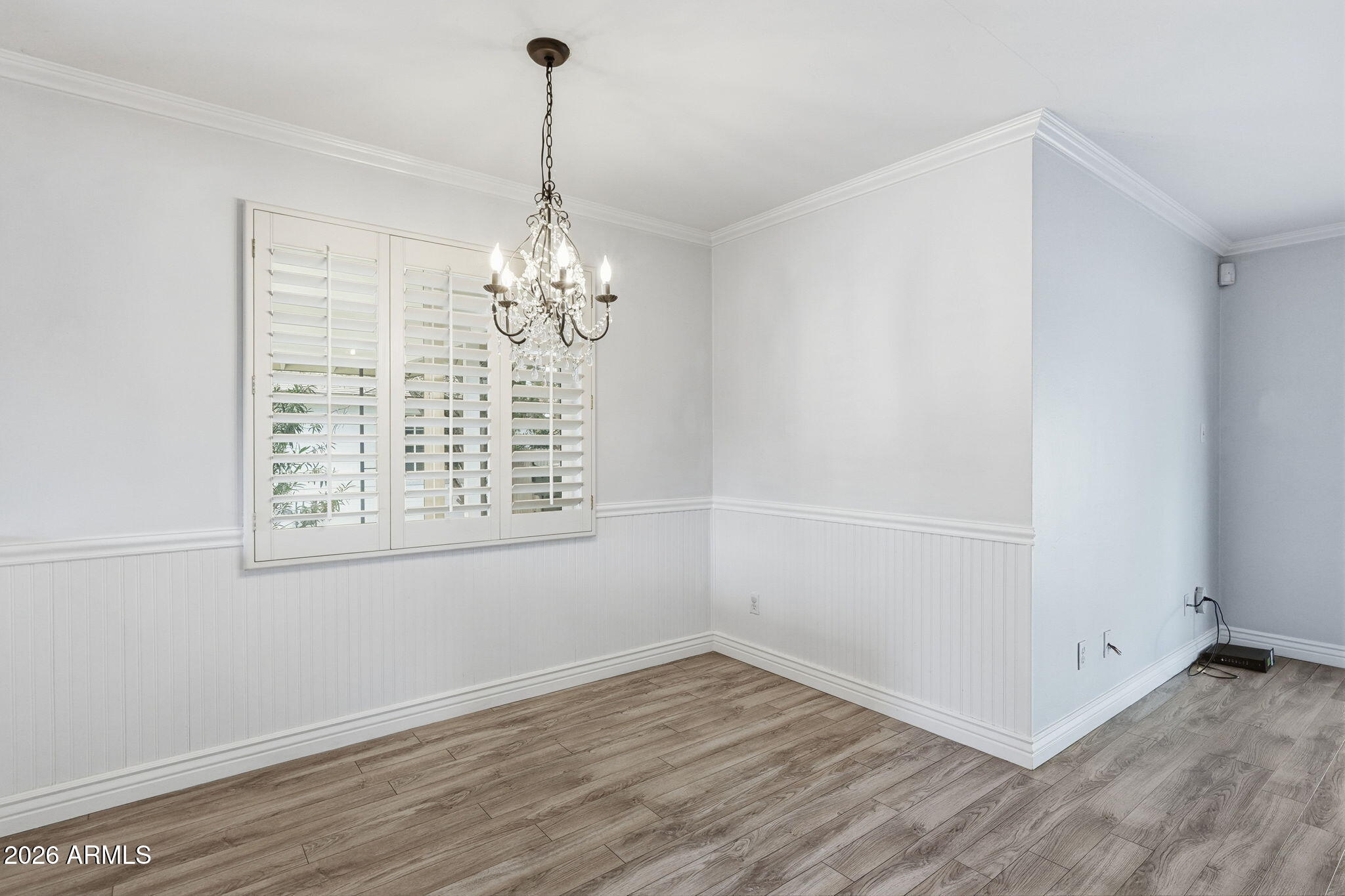 4702 North 30th Place Phoenix, AZ 85016 - Photo 14 of 34 an empty room with wooden floor chandelier and windows