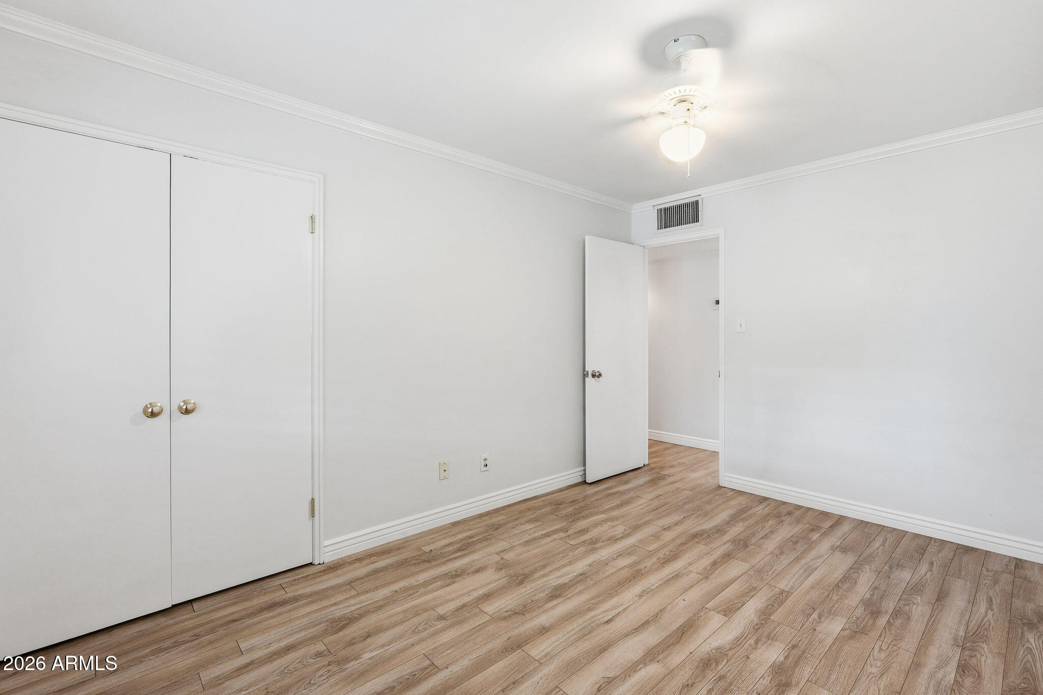 4702 North 30th Place Phoenix, AZ 85016 - Photo 18 of 34 a view of an empty room with wooden floor