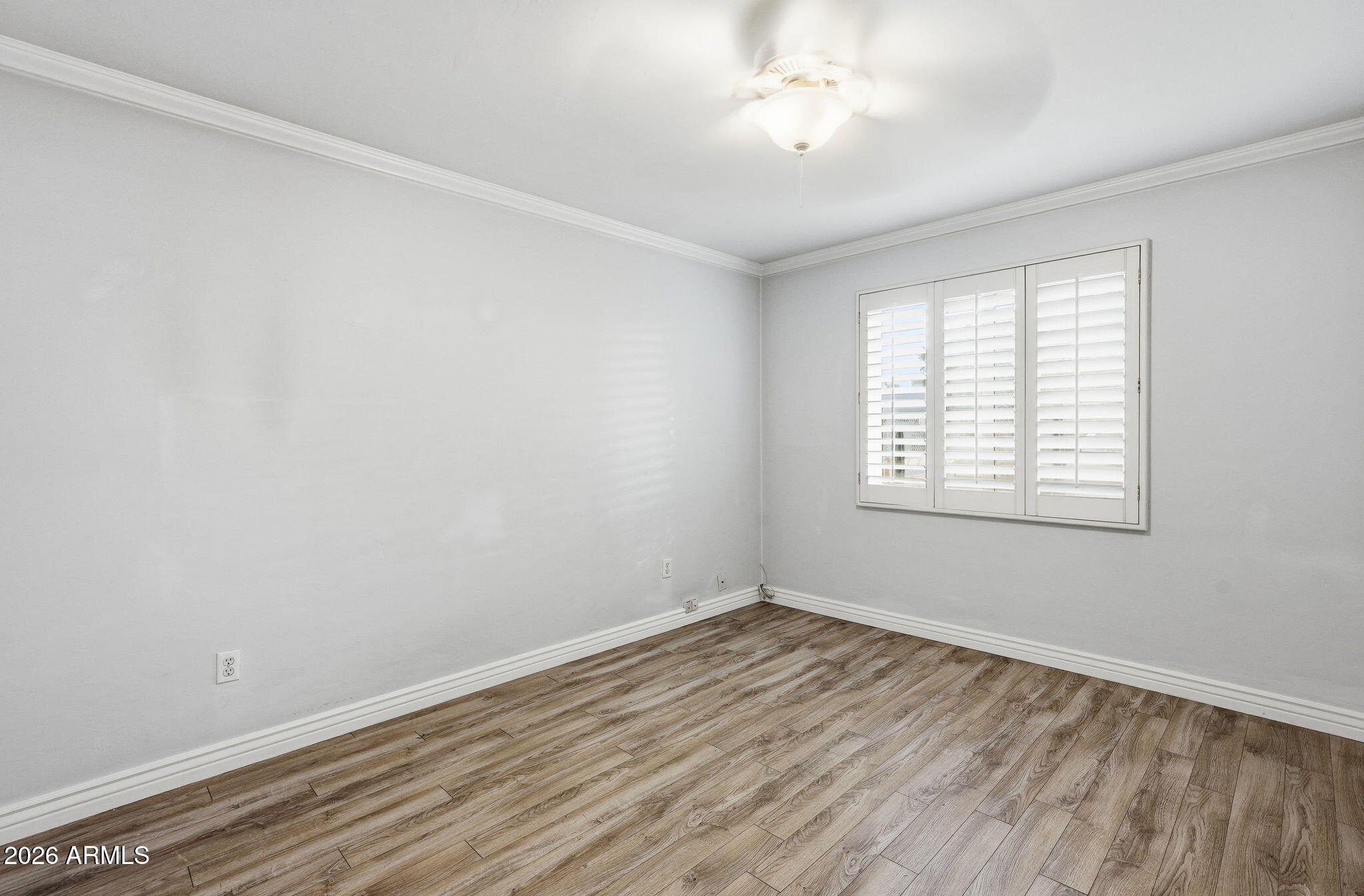 4702 North 30th Place Phoenix, AZ 85016 - Photo 21 of 34 wooden floor in an empty room with a window