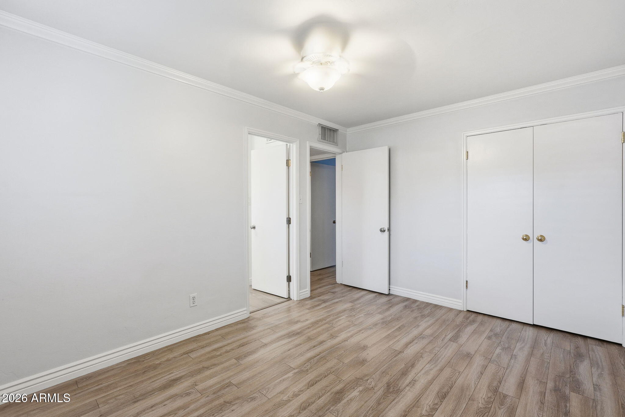 4702 North 30th Place Phoenix, AZ 85016 - Photo 23 of 34 a view of an empty room with wooden floor