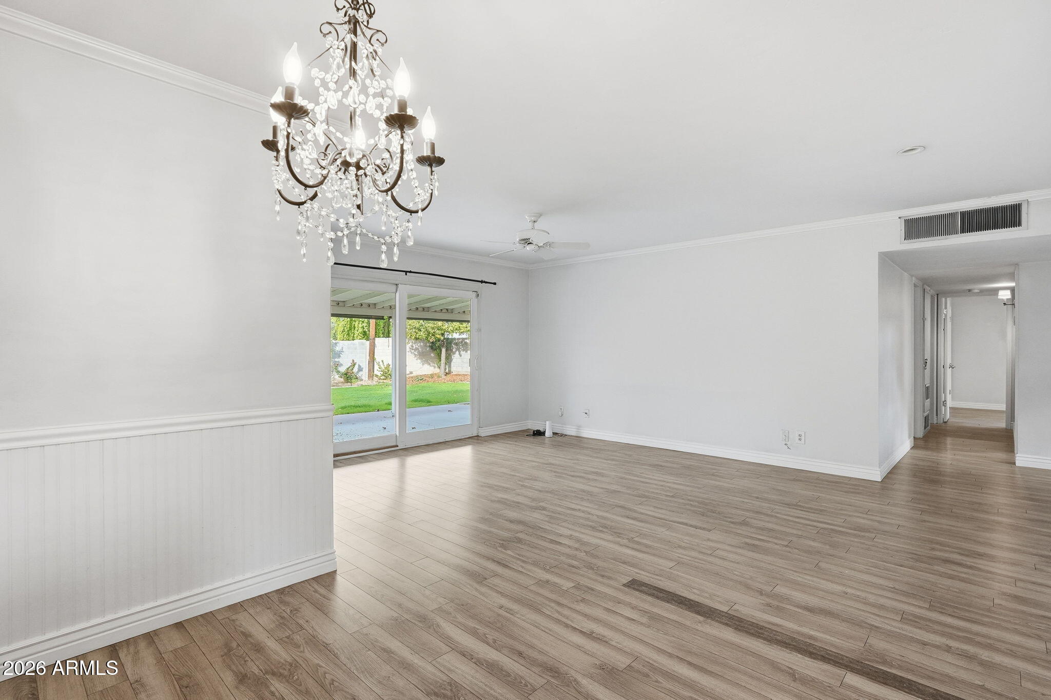 4702 North 30th Place Phoenix, AZ 85016 - Photo 5 of 34 a view of an empty room with wooden floor and a window